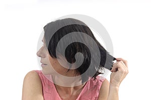 Woman touching her hair on white