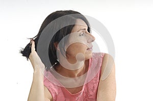 Woman touching her hair on white