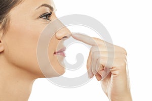 Woman touching her nose