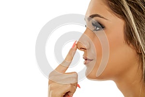 Woman touching her nose