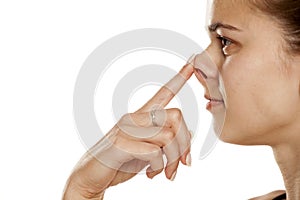 Woman touching her nose