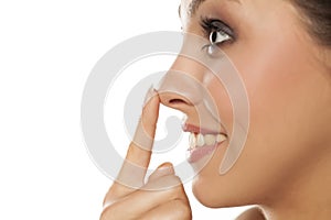 Woman touching her nose