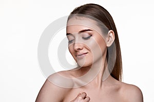 woman touching her shoulder and enjoying perfect soft clean skin