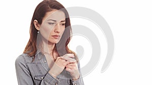 Woman touching her wedding ring thinking about marriage problems isolated