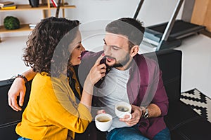 Woman touching nose of her boyfriend