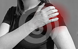 Woman touching painful shoulder with red point. Arm ache, swelling. Overuse, rotator cuff tendons injury, dislocation
