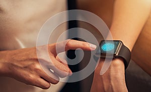 Woman touching and scanning fingerprint on smart watch to unlock, Concept digital security and private data access in technology.