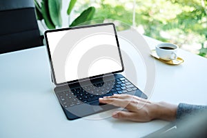 A woman touching on tablet touchpad with blank white desktop screen as computer pc in the office