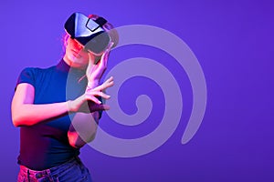 Woman touching a virtual button with VR set