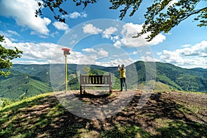 Woman and tourist attraction bench on top of the hill Cipcie in Slovakia