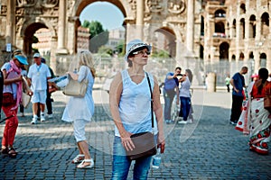 Woman tourist on the background of arch of Constantine