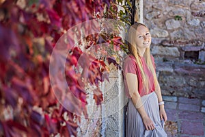 Woman tourist on background of beautiful view of the island of St. Stephen, Sveti Stefan on the Budva Riviera, Budva