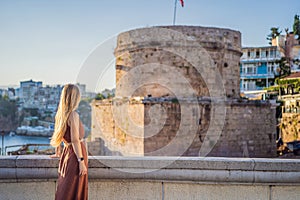 Woman tourist on background of Hidirlik Tower in Antalya against the backdrop of the Mediterranean bay of the ancient photo
