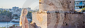 Woman tourist on background of Hidirlik Tower in Antalya against the backdrop of the Mediterranean bay of the ancient photo