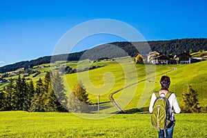 Woman-tourist with backpack admire in Dolomites, Tirol