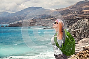 Woman tourist backpacker enjoying journey, unity with nature.