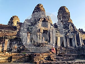 Woman tourist in Bayon temple in Angkor Wat