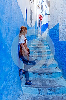 Woman tourist in beautiful blue street in Chefchaouen