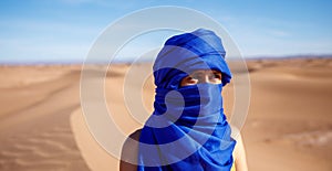 woman tourist with blue turban in the sahara