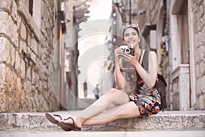 Woman tourist capturing memories.Young woman tourist,nomad,backpacker.Beautiful woman traveling alone.Korcula, Dubrovnik,Croatia t photo