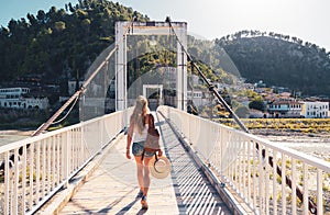 Woman tourist crossing bridge in Berat city photo