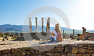 Woman tourist enjoying beautiful Volubilis site in Morocco