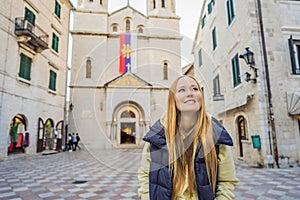 Woman tourist enjoying Colorful street in Old town of Kotor on a sunny day, Montenegro. Travel to Montenegro concept