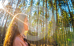 Woman tourist enjoying fresh air in the woods photo