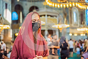 Woman tourist enjoying Hagia Sofia, Ayasofya interior in Istanbul, Turkey, Byzantine architecture, city landmark and