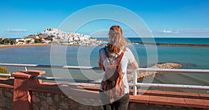 Woman tourist enjoying panoramic view of Peniscola city