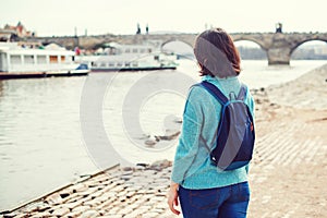 Woman tourist enjoying Prague view. Follow me to Prague. Back view of woman standing at Vltava riverbank. Happy holidays in Europe