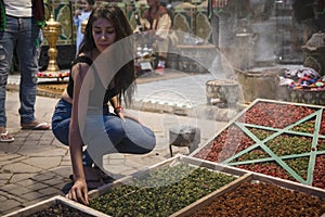 Woman tourist enjoying the streets where there are spices and incense from an Arab store in the city of Marrakech in the Jemaa