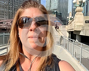 Woman tourist enjoying summer on Chicago riverwalk