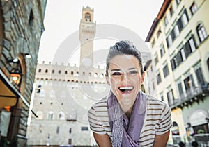 Woman tourist in the front of Palazzo Vecchio in Florence, Italy