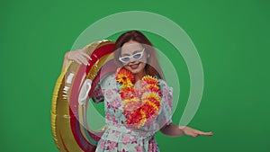 Woman tourist in glasses and flower wreath holds inflatable tube ring, dancing and chilling at the pool party, having