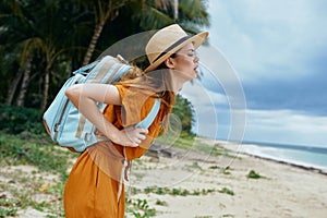 Woman tourist with heavy backpack travel to island landscape