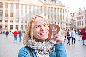 Woman tourist holding a bar of chocolate at the Grand Place in Brussels, Belgium