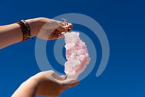Woman holding natural pink salt crystals in hands. Scenic Pink Lake Hutt Lagoon, WA