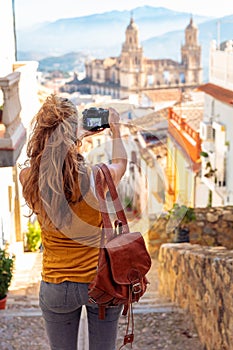 Woman tourist at Jaen, taking photography of the cathedral