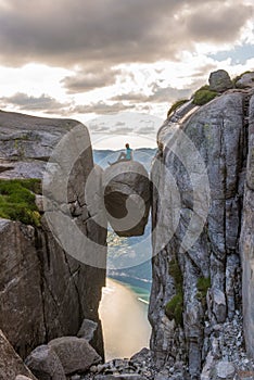 Woman tourist on Kjeragbolten Travel Norway Kjerag mountains