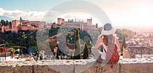 Woman tourist looking at Ancient arabic fortress Alhambra