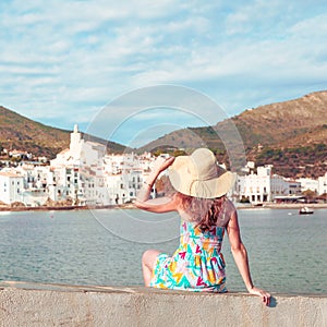 Woman tourist looking at city landscape of Cadaques