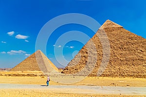 Woman tourist looking at the Great Pyramids of Egypt