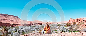 Woman tourist looking at Kasbah, Ait ben haddou