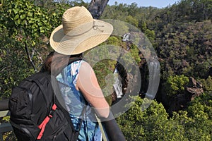 Woman tourist looking at lorence Falls in Litchfield National Park Northern Territory Australia