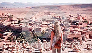 Woman tourist looking at panoramic view of Ait Ben Haddou city