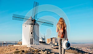 Woman tourist looking at windmills ,Consuegra near Toledo