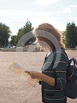 Woman tourist with map on the street. Travel guide, tourism in Europe. The ancient city of Gatchina.