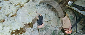 The woman tourist marveled at the rock stone formations in the dark cavern. The cave excursion travel experience. Its an