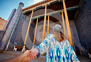 Woman tourist at old city Khiva in Uzbekistan